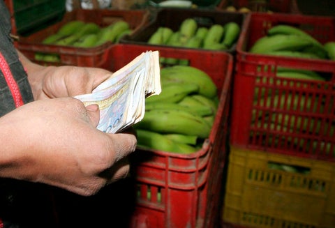 Un tendero contando sus ganancias en el mercado