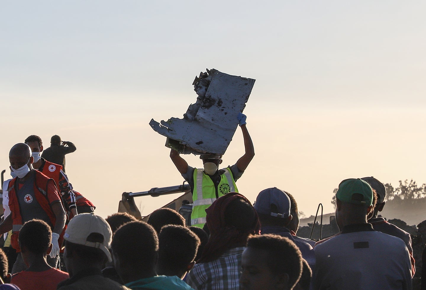 Una persona sujeta una parte del avión siniestrado en Bishoftu, en inmediaciones de Addis Ababa, en Etiopía
