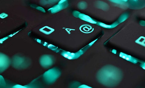 Teclado de computador de color negro con luces azules