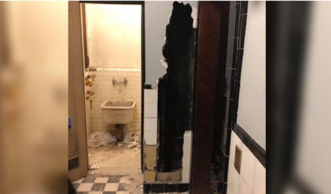 Hombre atrapado en pared de baño