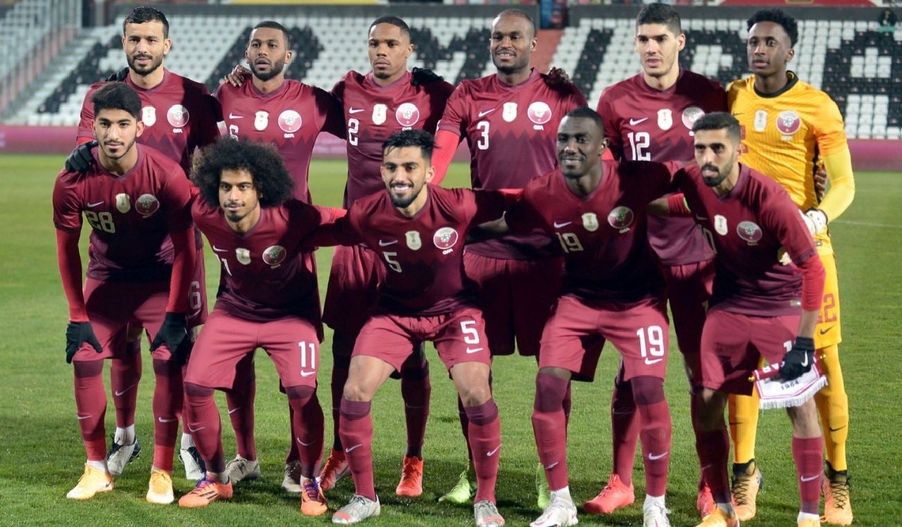 Deportistas uniformados posando para una foto en un campo de fútbol
