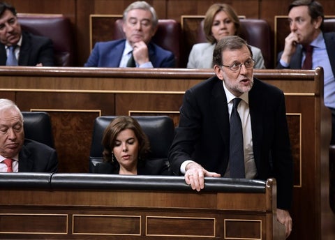 Spanish acting Prime Minister, Mariano Rajoy (bottom R) shouts his vote during the parliamentary investiture vote for a prime...