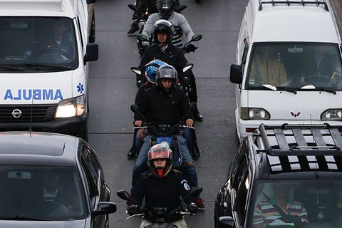 Conductores de moto en medio de un trancón