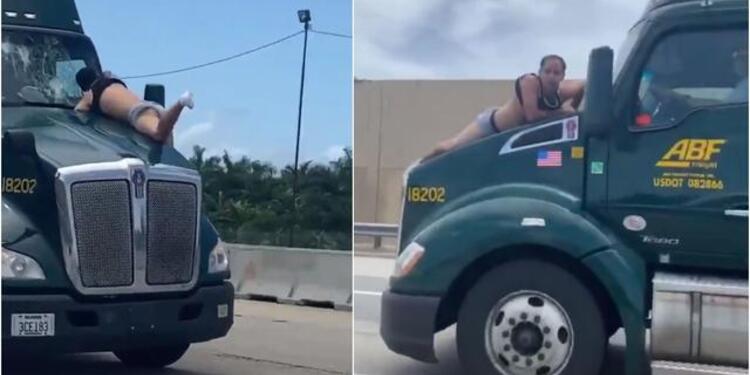 Hombre aferrado a un camión