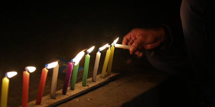 Velas encendidas en un andén Uso de velas en día de las velitas