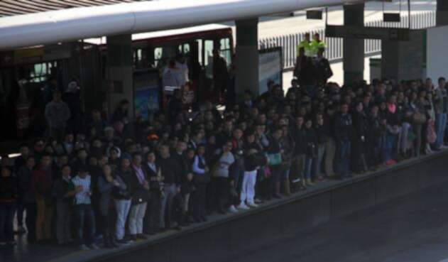 Ciudadanos esperando el bus de Transmilenio Ciudadanos esperando el bus de Transmilenio