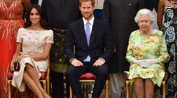 Reina Isabel II, príncipe Harry y Meghan Markle
