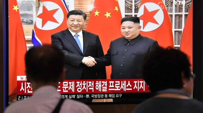 Xi Jinping y Kim Jong-un Xi Jinping y Kim Jong-un