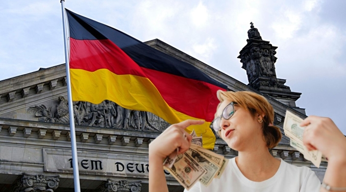 Empleo en Alemania para colombianos Bandera de Alemania y persona con dólares