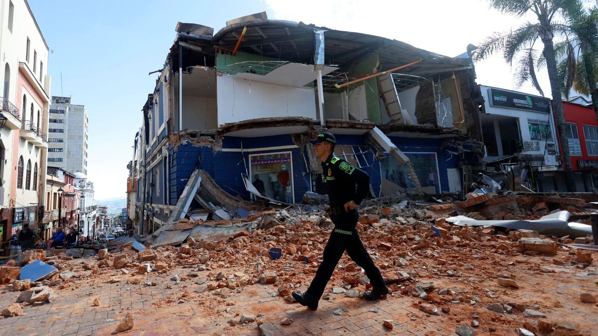 Un agente de policía camina en Manizales entre los escombros de un local comercial dañado, tras el terremoto de 7,4 grados de intensidad que sacudió a Colombia.